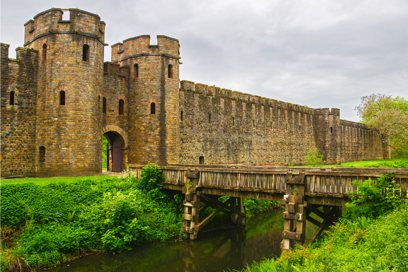 Cardiff castle with a drawbridge over a moat on a cloudy day